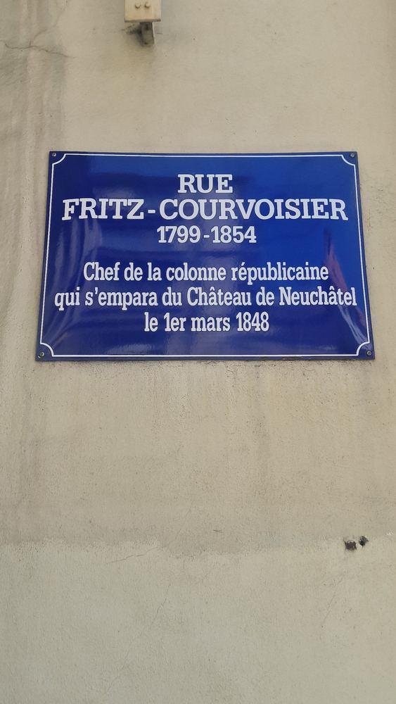 Blue street plaque: Rue Fritz-Courvoisier 1799–1854