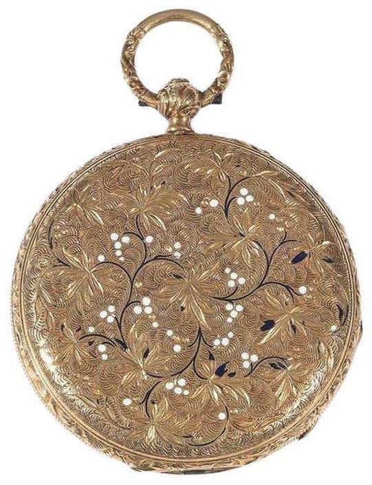 Gold pocket watch with engraved foliage and enamel dots on the case